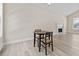 Open dining area with hardwood floors and a view of the fireplace in the living room at 2140 Wildcat Cliffs Way, Lawrenceville, GA 30043
