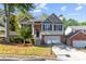 Charming two-story home with brick accents, a well-manicured lawn, and an attached two-car garage at 2140 Wildcat Cliffs Way, Lawrenceville, GA 30043