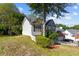 A two-story home featuring siding, a manicured lawn and mature trees at 2140 Wildcat Cliffs Way, Lawrenceville, GA 30043