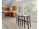 Open kitchen and dining area with stainless steel appliances, hardwood floors, and ample counter space at 2140 Wildcat Cliffs Way, Lawrenceville, GA 30043