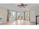 A living room featuring hardwood floors, natural light from many windows, French doors, and ceiling fan at 2140 Wildcat Cliffs Way, Lawrenceville, GA 30043