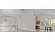 Open-concept living space with vaulted ceilings, hardwood floors, and views into the kitchen area at 2140 Wildcat Cliffs Way, Lawrenceville, GA 30043