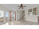 An open living room featuring hardwood floors, staircase and natural light from windows and French doors at 2140 Wildcat Cliffs Way, Lawrenceville, GA 30043