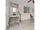 An open living room featuring gleaming hardwood floors, a staircase, and natural light from windows at 2140 Wildcat Cliffs Way, Lawrenceville, GA 30043
