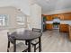 Open living space featuring hardwood floors connecting the kitchen, dining area, and living room at 2140 Wildcat Cliffs Way, Lawrenceville, GA 30043