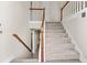 Inviting foyer features a staircase with carpeted steps and wood railing leading to the upper level at 2140 Wildcat Cliffs Way, Lawrenceville, GA 30043