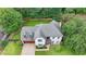 Aerial view of a two-story home with a well-manicured lawn, attached garage, and lush landscaping, showcasing its layout at 3085 Saint Andrews Dr, Duluth, GA 30096