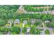 Aerial view of a property with a well-manicured lawn, landscaping, a home and a defined yellow border in a wooded area at 3085 Saint Andrews Dr, Duluth, GA 30096