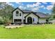 Large backyard with a stone patio, seating area, and well-maintained lawn at 3085 Saint Andrews Dr, Duluth, GA 30096
