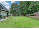Large, well-maintained backyard with a lush lawn, stone border and wooden fence, offering ample space for recreation at 3085 Saint Andrews Dr, Duluth, GA 30096