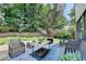 Outdoor deck featuring cozy seating, table, and a lush green yard with privacy fence and plantings at 3085 Saint Andrews Dr, Duluth, GA 30096