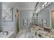 Main bathroom featuring double sinks, granite counters, soaking tub, and a glass shower at 3085 Saint Andrews Dr, Duluth, GA 30096