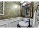 Powder room features a pedestal sink, modern faucet and decorative mirror at 3085 Saint Andrews Dr, Duluth, GA 30096