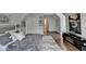 Comfortable bedroom with closet, open hallway, attractive artwork, and fuzzy gray rug on hardwood floor at 3085 Saint Andrews Dr, Duluth, GA 30096