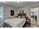 Bedroom featuring a comfortable bed, an elephant art, and view to hallway with hardwood floors at 3085 Saint Andrews Dr, Duluth, GA 30096