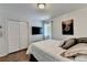 Cozy bedroom featuring a comfortable bed, an accent wall art, and a closet over hardwood floors at 3085 Saint Andrews Dr, Duluth, GA 30096