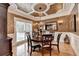 Formal dining room featuring a decorative ceiling, elegant lighting, and a large window for abundant natural light at 3085 Saint Andrews Dr, Duluth, GA 30096