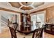 Dining room boasts a coffered ceiling, chandelier, and large window; perfect for elegant dinners and gatherings at 3085 Saint Andrews Dr, Duluth, GA 30096