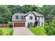 Charming white brick home with a well-manicured lawn and attached two-car garage at 3085 Saint Andrews Dr, Duluth, GA 30096