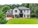 Charming two-story home with a brick facade, a well-manicured lawn, and an attached garage, offering great curb appeal at 3085 Saint Andrews Dr, Duluth, GA 30096