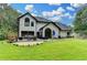 Rear exterior view showcasing a well-manicured lawn, patio with furnishings, and large, modern home at 3085 Saint Andrews Dr, Duluth, GA 30096