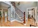 Elegant foyer with wood floors, staircase, wrought iron details, and decorative accents at 3085 Saint Andrews Dr, Duluth, GA 30096