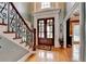 Grand foyer with hardwood floors, a striking staircase, and an elegant doorway, creating a welcoming entrance at 3085 Saint Andrews Dr, Duluth, GA 30096