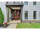 Inviting front entrance with a wood door, decorative columns, and manicured landscaping at 3085 Saint Andrews Dr, Duluth, GA 30096