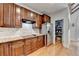 Well-lit kitchen boasts dark wood cabinets, granite countertops and stainless steel refrigerator at 3085 Saint Andrews Dr, Duluth, GA 30096