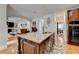 Gourmet kitchen island with granite countertop, seating and views into the living room at 3085 Saint Andrews Dr, Duluth, GA 30096
