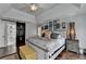 Spacious main bedroom with tray ceilings, barn door to bathroom and wood flooring at 3085 Saint Andrews Dr, Duluth, GA 30096