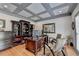 Home office featuring custom built-ins, a large desk, and a sophisticated coffered ceiling at 3085 Saint Andrews Dr, Duluth, GA 30096
