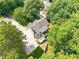Home in a lush neighborhood; view showcases mature trees, landscaping, an extended driveway, a backyard, and the surrounding area at 3440 Canyon Oak Way, Cumming, GA 30041