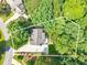 An aerial shot with property lines drawn showing the home's location and the greenery around it at 3440 Canyon Oak Way, Cumming, GA 30041