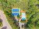Aerial view of tennis courts and community pool surrounded by lush greenery at 3440 Canyon Oak Way, Cumming, GA 30041