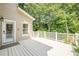 Expansive white painted back deck perfect for entertaining with access to the home's side entrance at 3440 Canyon Oak Way, Cumming, GA 30041