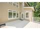 A sun-drenched back deck offers an inviting space for outdoor entertaining, featuring neutral tones, and views of the surrounding trees at 3440 Canyon Oak Way, Cumming, GA 30041