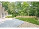 A backyard featuring a manicured lawn, framed by a wooden fence and a concrete patio area at 3440 Canyon Oak Way, Cumming, GA 30041