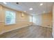 Spacious basement area with light-colored walls and flooring, two bright windows, and access door at 3440 Canyon Oak Way, Cumming, GA 30041