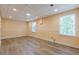 Basement area with large windows bringing in natural light, light-colored walls, and sleek flooring at 3440 Canyon Oak Way, Cumming, GA 30041