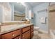Well-appointed bathroom with granite countertop vanity, stylish fixtures, and a combination shower and tub at 3440 Canyon Oak Way, Cumming, GA 30041