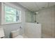Bathroom with white-tiled shower and toilet, offering a fresh and modern space at 3440 Canyon Oak Way, Cumming, GA 30041