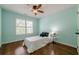 Light-filled bedroom with hardwood floors, a ceiling fan, a window with shutters, and stylish decor at 3440 Canyon Oak Way, Cumming, GA 30041