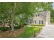 Traditional two-story home featuring a front porch, manicured lawn, and attached garage at 3440 Canyon Oak Way, Cumming, GA 30041