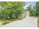 Charming home boasts a long driveway, attached garage, and well-manicured lawn, creating excellent curb appeal in a lush setting at 3440 Canyon Oak Way, Cumming, GA 30041