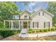 Traditional home with a welcoming front porch, balanced landscaping, and classic architectural details at 3440 Canyon Oak Way, Cumming, GA 30041