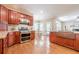 Chef's kitchen with a gas range, double oven, a copper sink, and granite countertops at 3440 Canyon Oak Way, Cumming, GA 30041