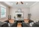 Cozy living room featuring a fireplace, hardwood floors, and two comfortable chairs at 3440 Canyon Oak Way, Cumming, GA 30041