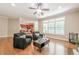 Open concept living room connects to kitchen with hardwood floors and natural light at 3440 Canyon Oak Way, Cumming, GA 30041