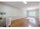 A versatile room featuring gleaming hardwood floors, crown molding, and a large window, perfect for a home office at 3440 Canyon Oak Way, Cumming, GA 30041